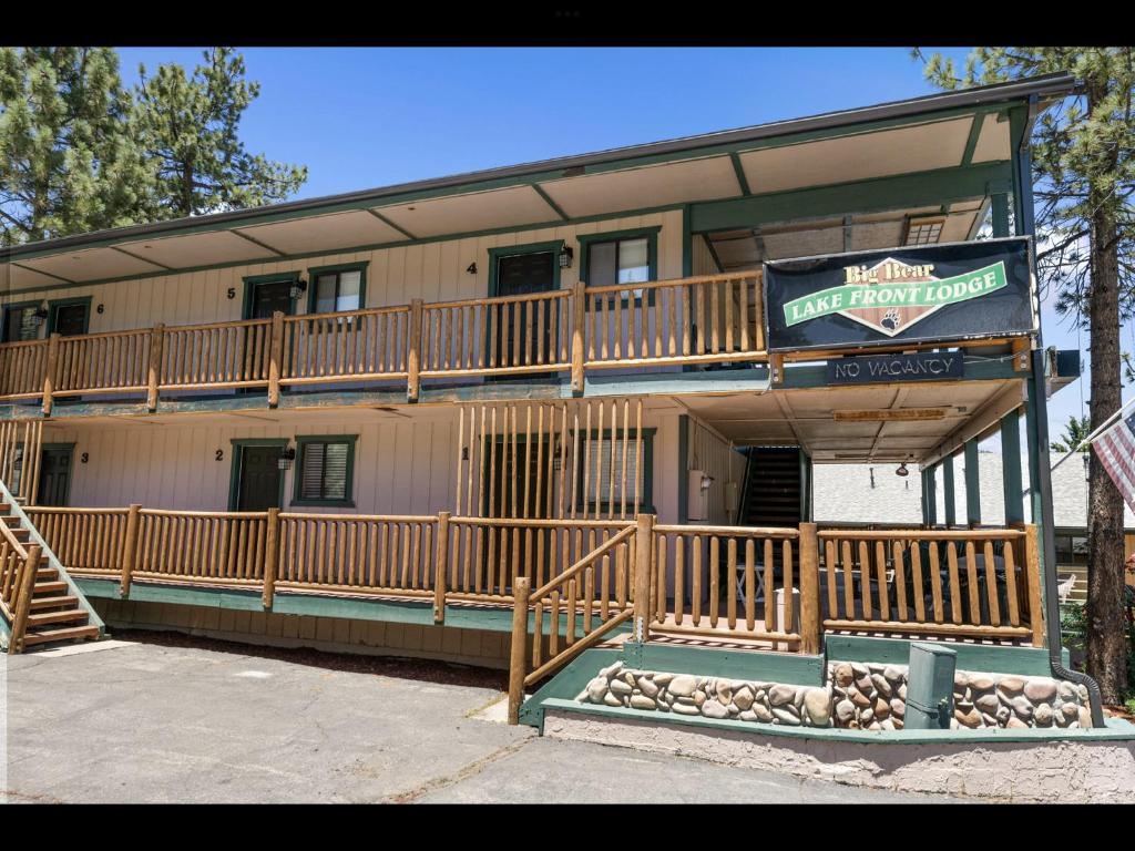 a building with a large deck with a sign on it at Big Bear Lake Front Lodge in Big Bear Lake