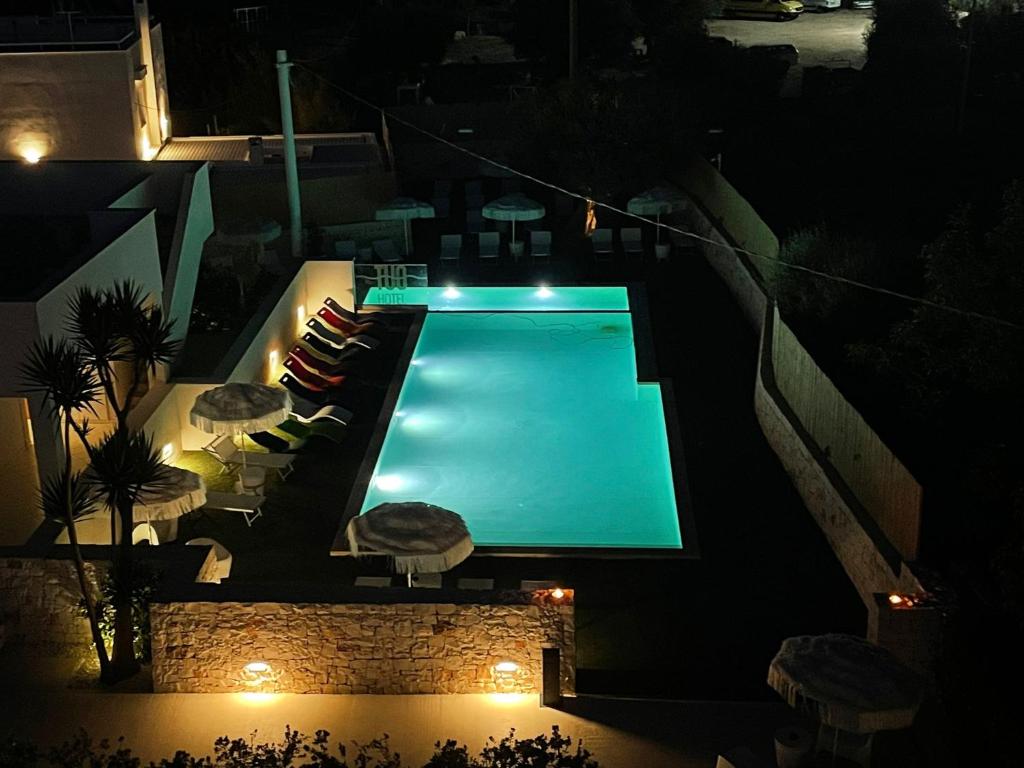 an overhead view of a swimming pool at night at Tuo Hotel in Polignano a Mare