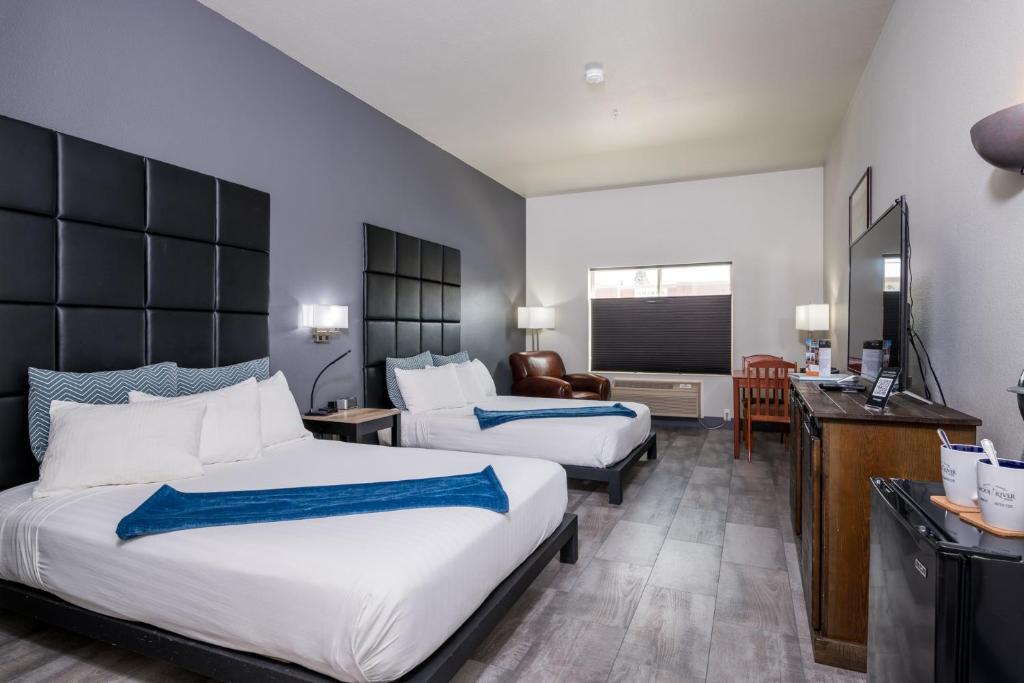 a hotel room with two beds and a television at Wood River Inn & Suite in Hailey