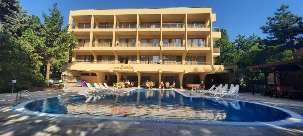 un hotel con piscina frente a un edificio en Hotel Exotica en Golden Sands
