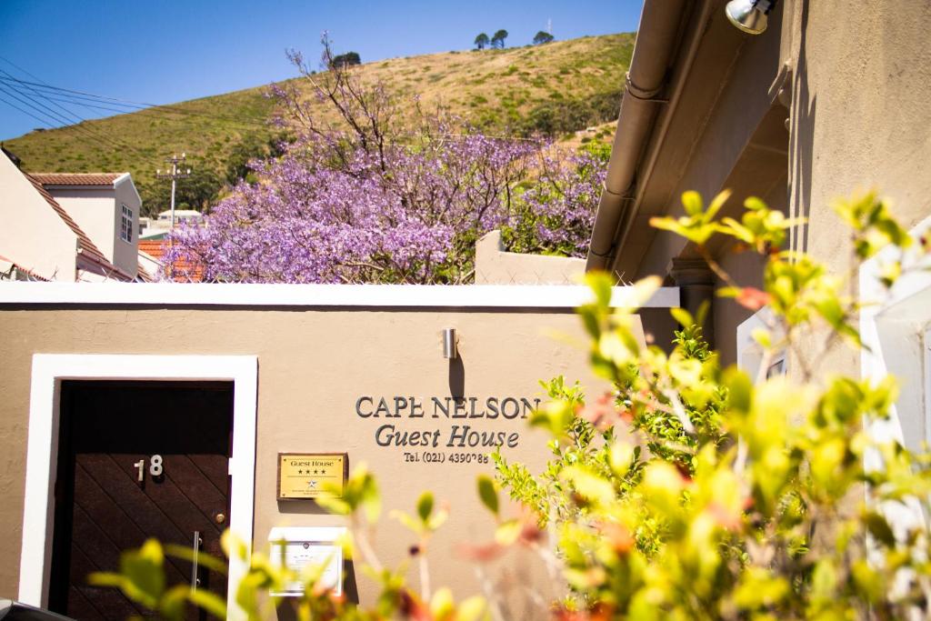 a building with a sign for a guest house at Cape Nelson Guest House in Cape Town