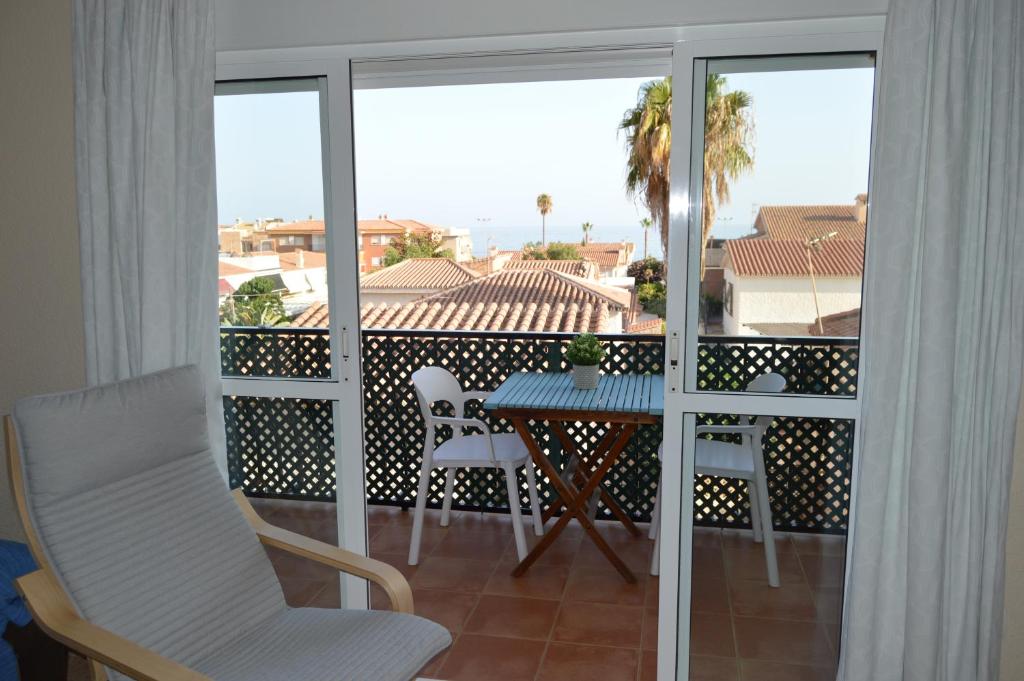a view of a balcony with a table and chairs at Irene Beach Málaga, Parking Gratuito in Cala del Moral