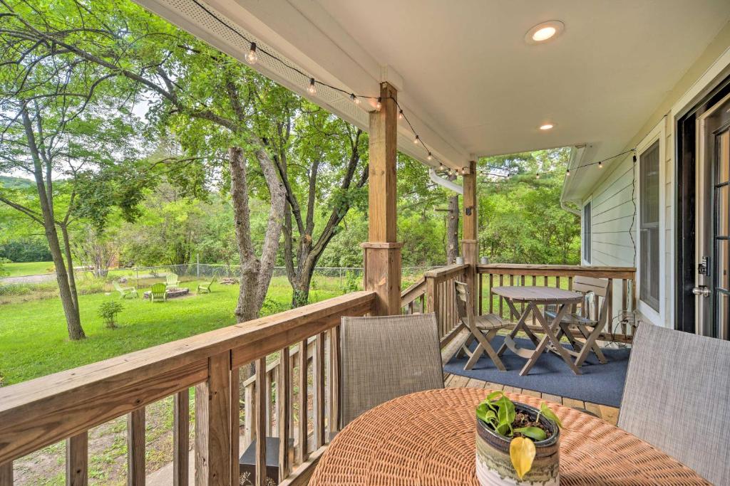 a deck with a table and chairs on a porch at Charming Taylors Falls Home with Deck, Fire Pit in Saint Croix Falls