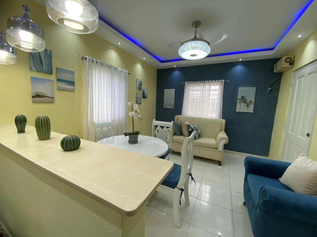 a living room with a couch and a table at Apartamentos Melya cerca de la Playa Caleta in La Romana