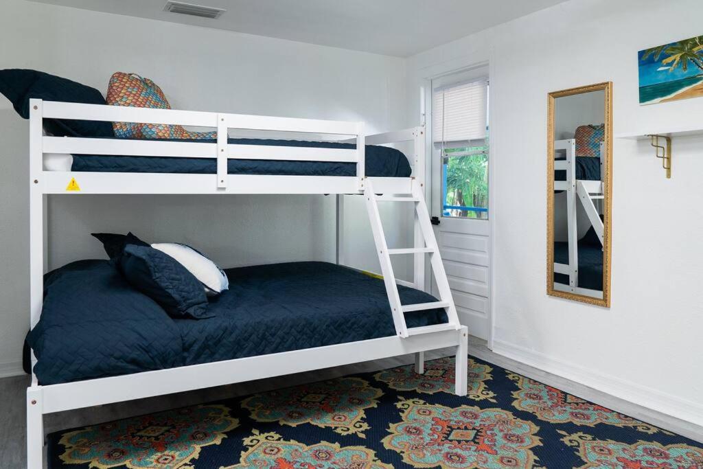 a bedroom with two bunk beds and a mirror at Welcome to The Bray Escape 4 miles to Siesta Key in Sarasota
