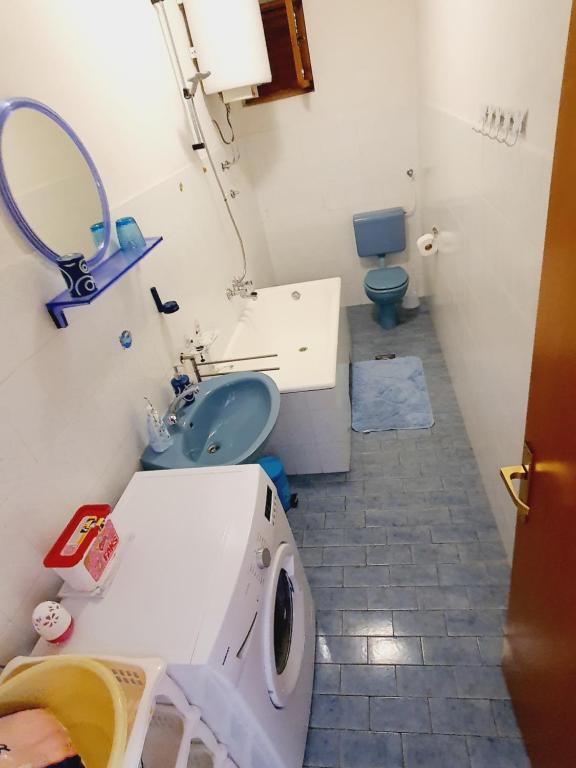 a small bathroom with a sink and a toilet at Apartment Nadalina in Seget Vranjica