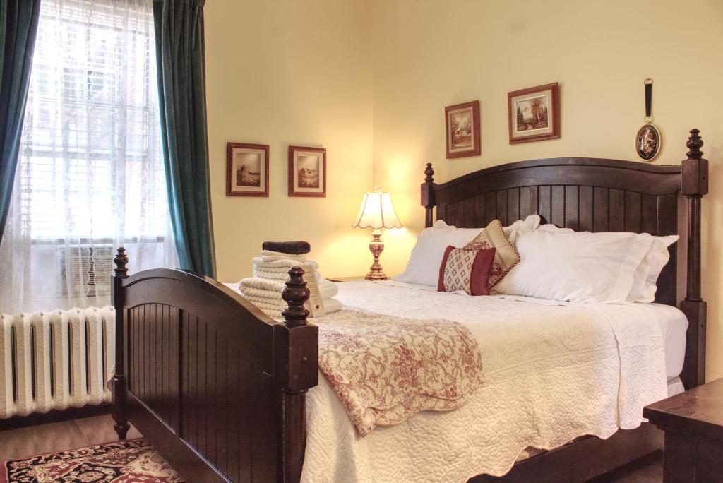 a bedroom with a large bed and a window at The Scotsman Inn in Pictou