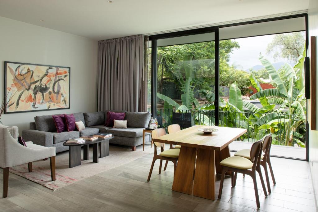 a living room with a couch and a table at El Callejón Hotel Boutique in Oaxaca City