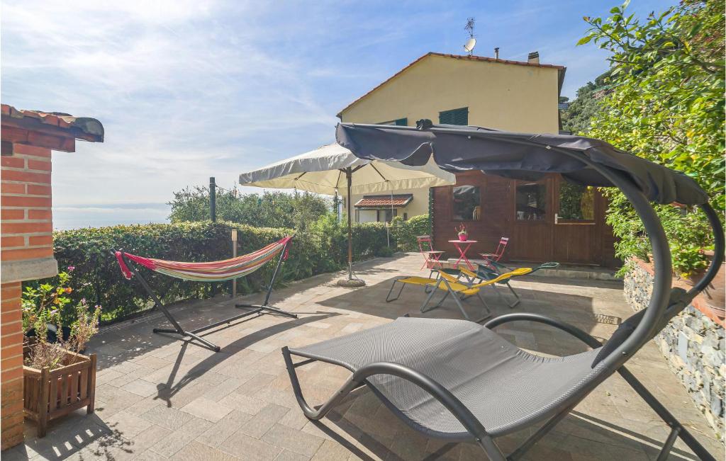 a patio with two chairs and an umbrella at 2 Bedroom Cozy Home In Camogli in Camogli