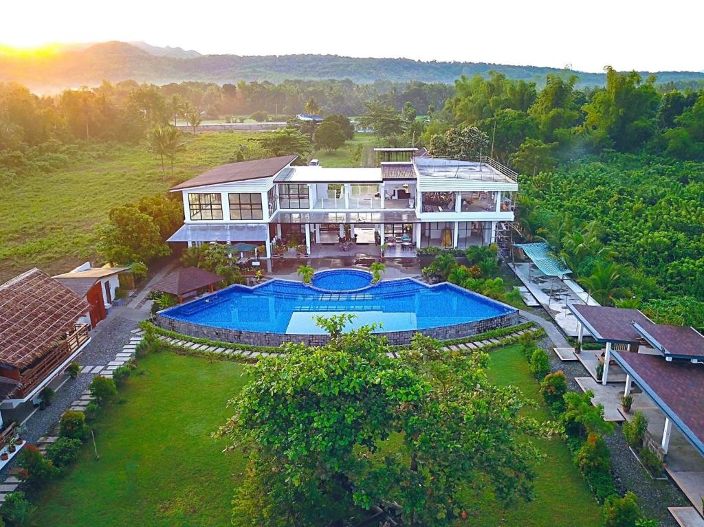 an aerial view of a large house with a swimming pool at Vistapaloma beach resort in Odiong