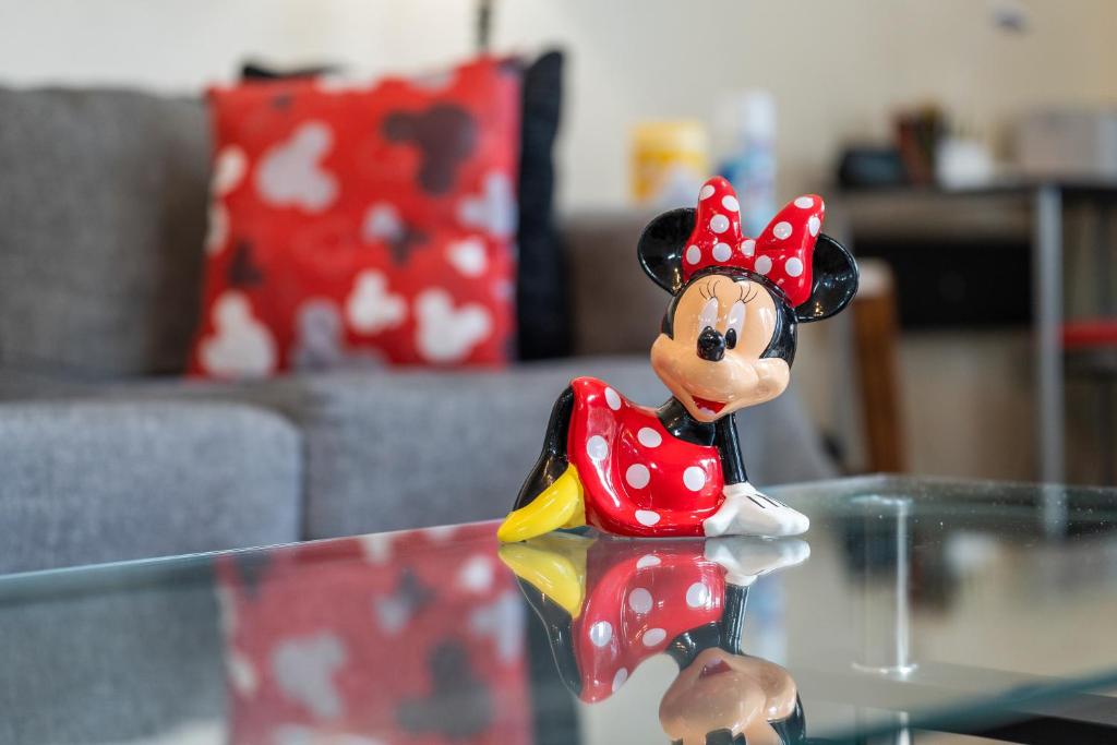 a toy figurine of a mickey mouse on a glass table at Perfect for Family, Wake up Next to the pool! in Kissimmee