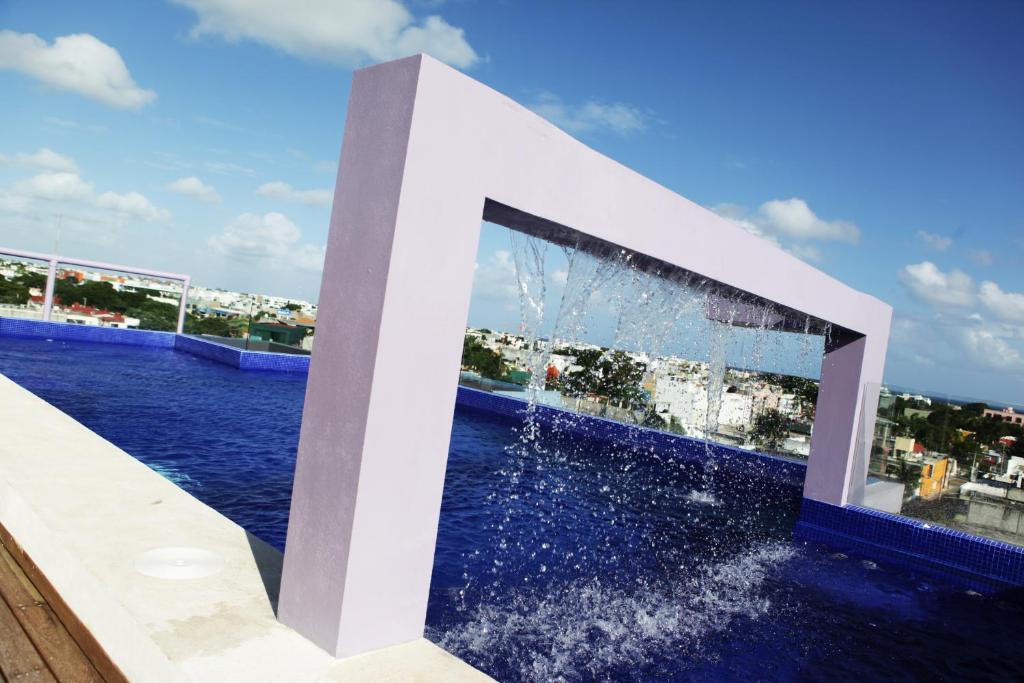 a fountain in the middle of a body of water at Iris Studios & Apartments in Playa del Carmen