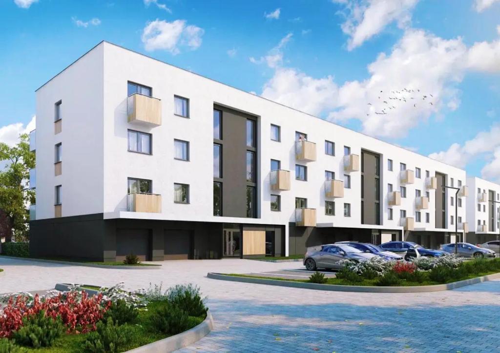 ヴロツワフにあるElegant 1-Bedroom Flat With Balcony Near Wrocławの駐車場車が停まった白い建物