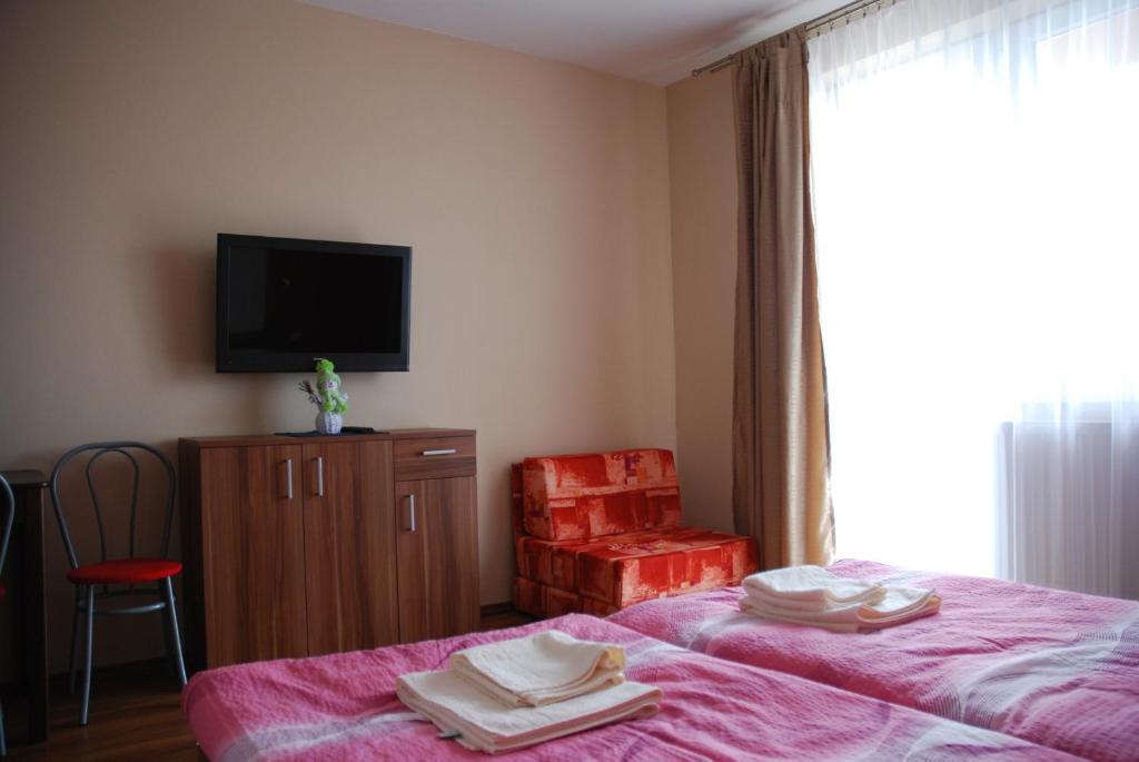 Postel nebo postele na pokoji v ubytování Fridrich apartman