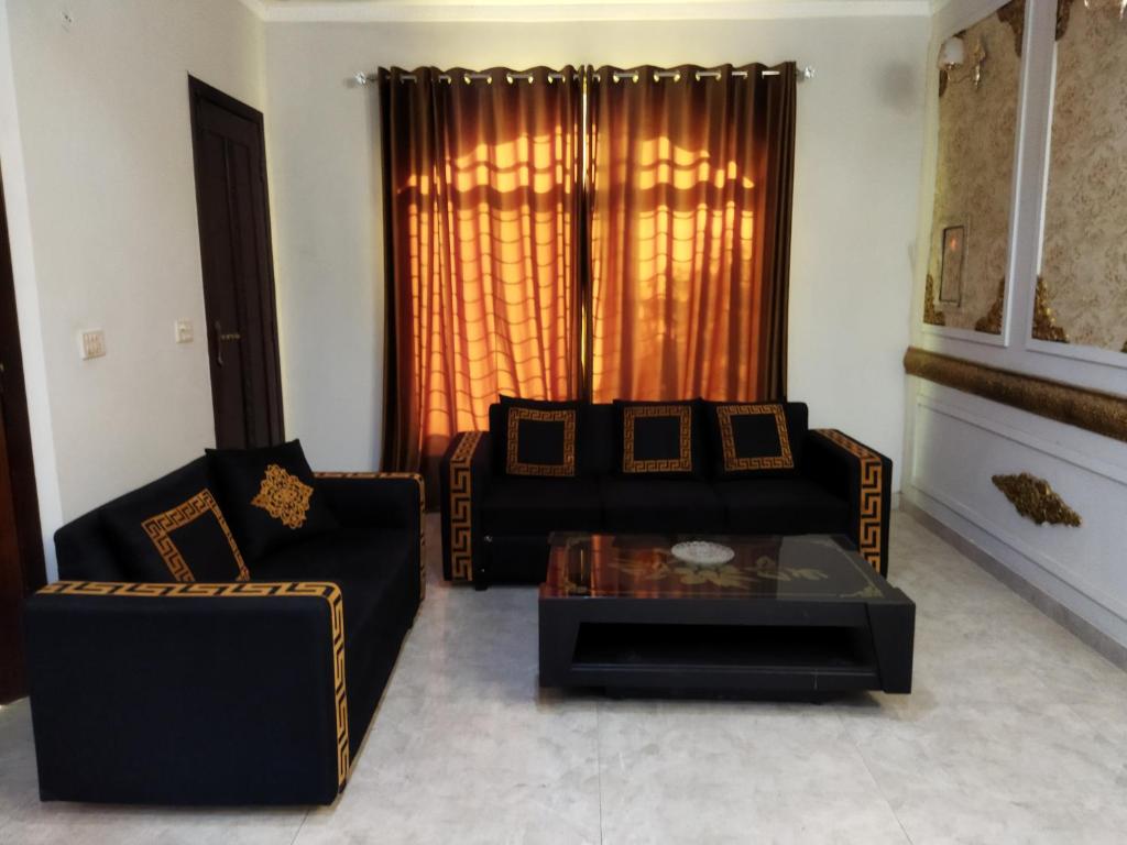 a living room with a couch and a coffee table at Furnished Private Ground Floor - Pasha House in Lahore