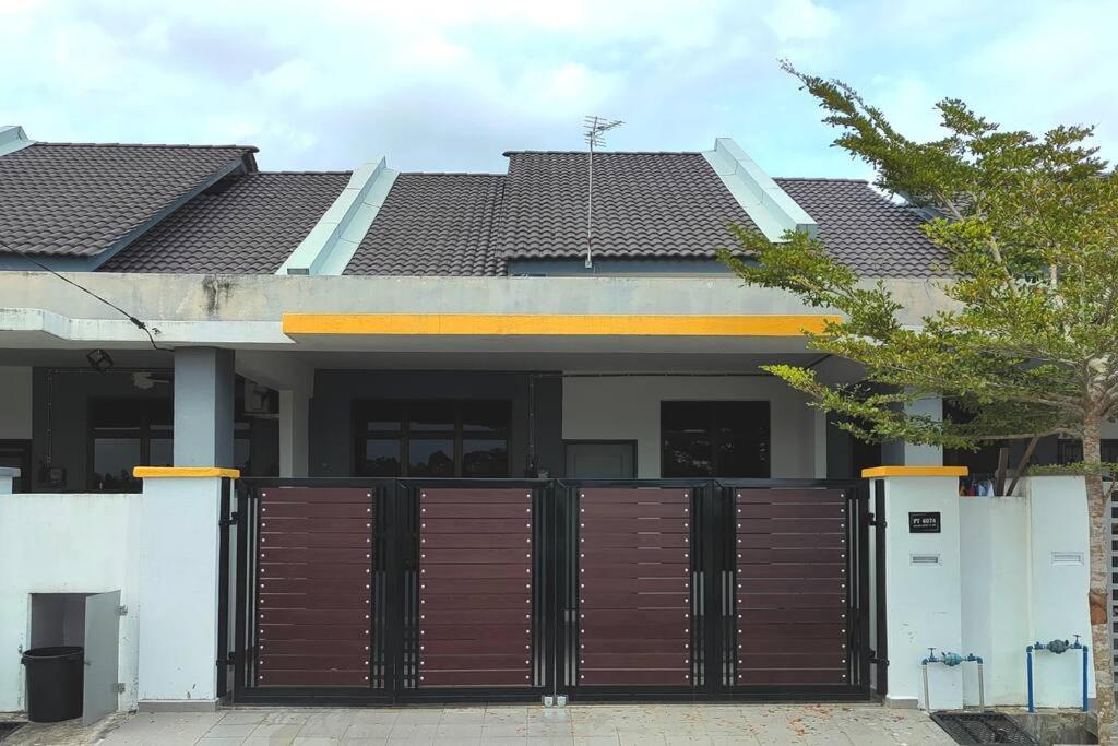 a house with a gate in front of it at Alam Perdana @ Kemaman Cukai in Cukai