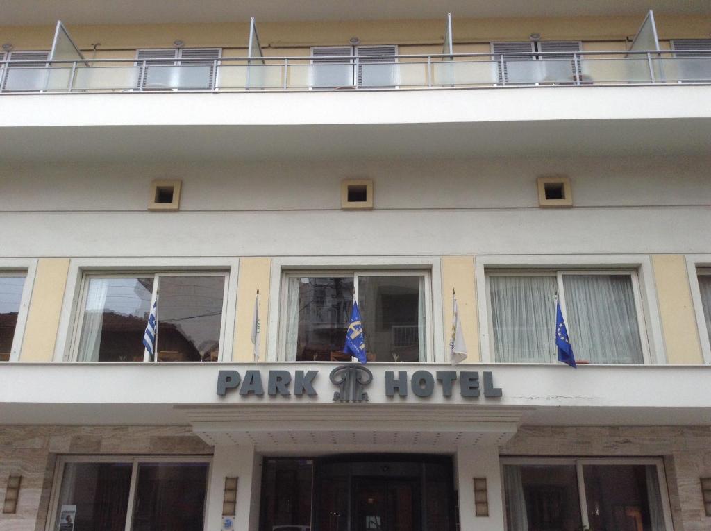 a hotel with flags in front of a building at Park Hotel in Volos