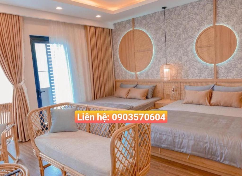 a bedroom with two beds and two chairs at Quy Nhon Chillin' Apartment - FLC Sea Tower Quy Nhơn Căn Hộ Hướng Biển in Quy Nhon