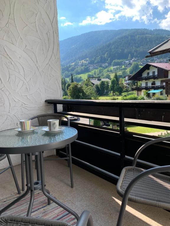 a table and chairs on a balcony with a view at Ski und Therme 2 in Bad Kleinkirchheim