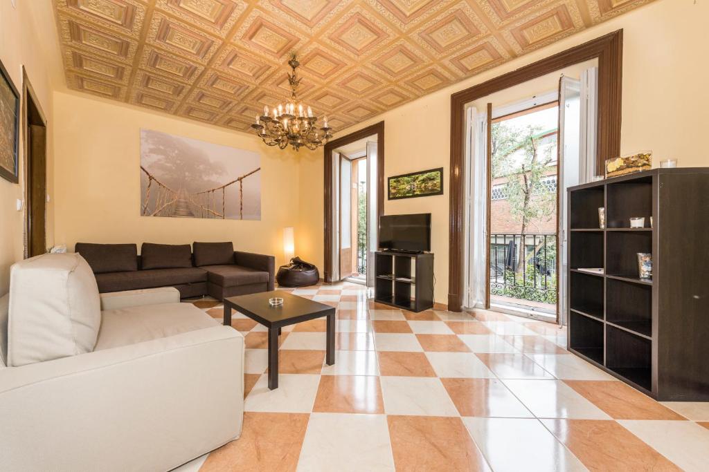 a living room with a couch and a table at Grand Latina Apartment in Madrid