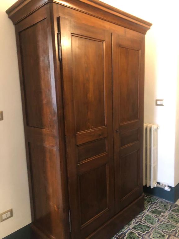 a large wooden cabinet in a room at Palazzo Bernardini Suites in Lecce