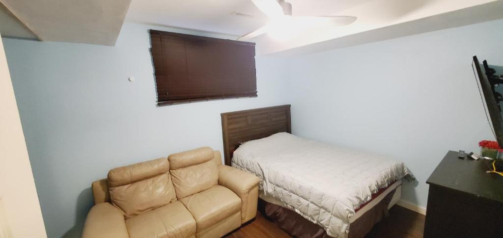 a living room with a couch and a bed at Studio Fort McMurray in Fort McMurray