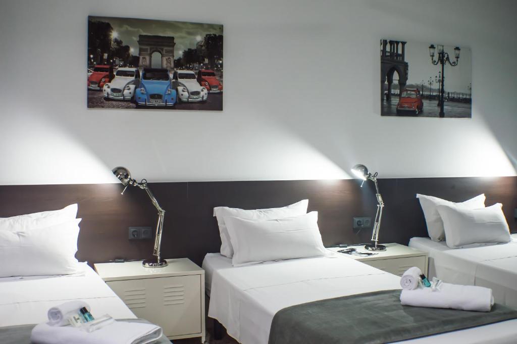 a hotel room with two beds and two lamps at Quart Youth Hostel & Apartments in Valencia