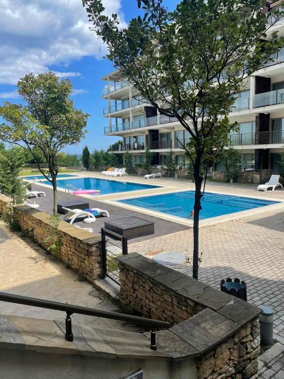 a swimming pool in front of a apartment building at YooBulgaria-Obzor SP apartments in Obzor