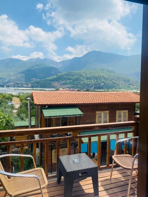 a patio with a table and chairs on a balcony at 7 Green Adrasan in Adrasan