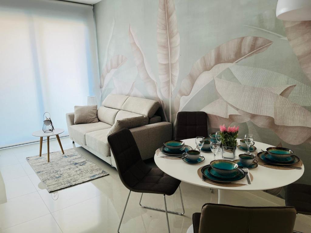 a living room with a table and a couch at NEW 2022 Casanovas-Apartment Torrevieja Center in Torrevieja