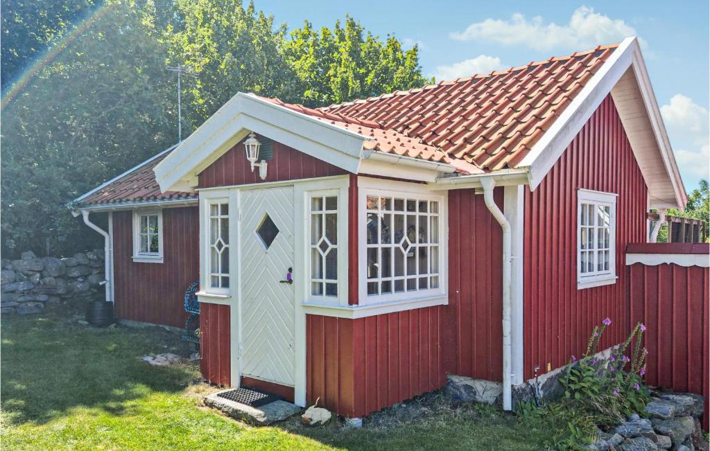 a red shed with a red roof at Gorgeous Home In sa With Wifi in Åsa