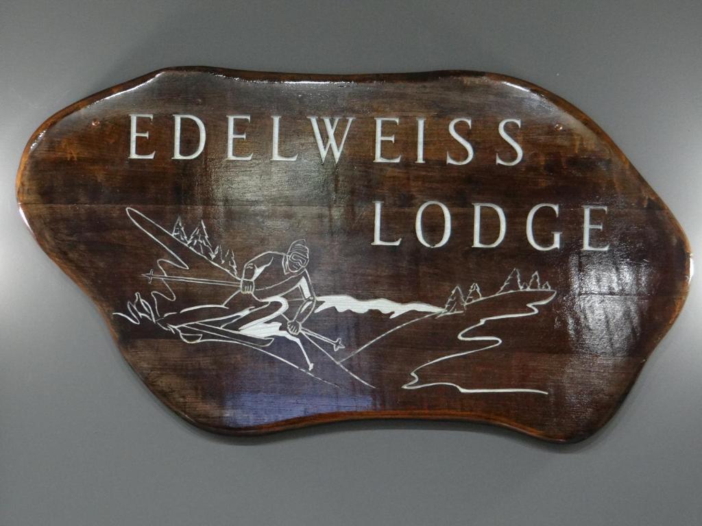 a sign that says evidences lodge with a picture of a person at Edelweiss Ski Lodge in Ellicottville