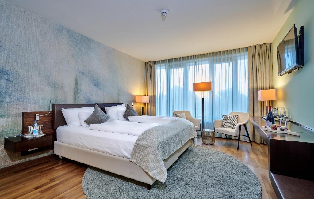 Postel nebo postele na pokoji v ubytování Asam Hotel
