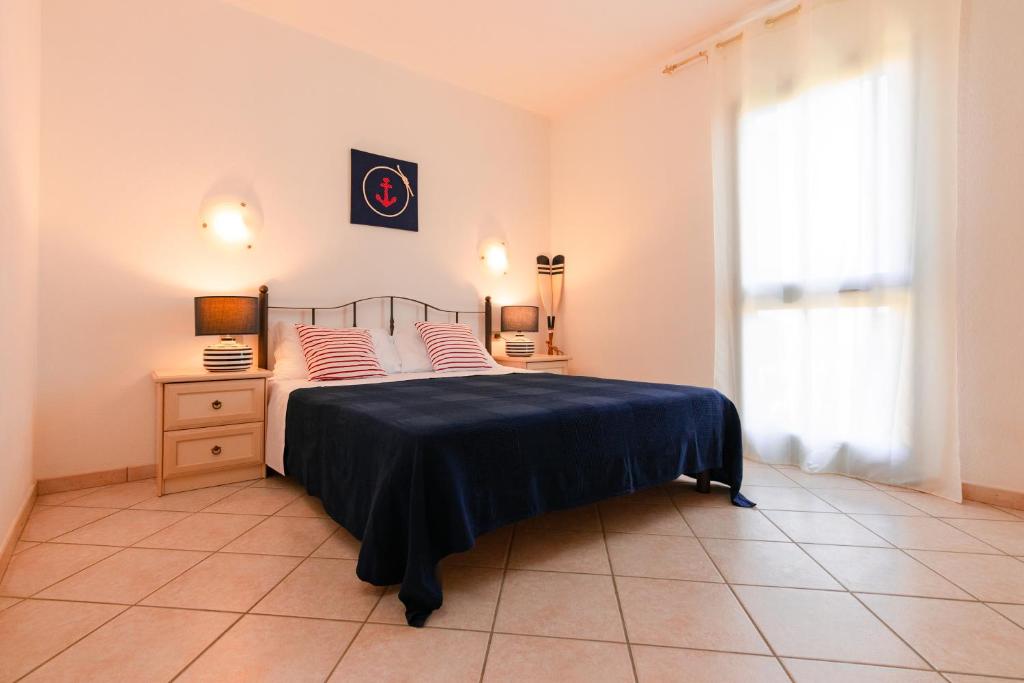 a bedroom with a bed and a dresser at Residence SardegnaSummer Li Cuppulati in San Teodoro