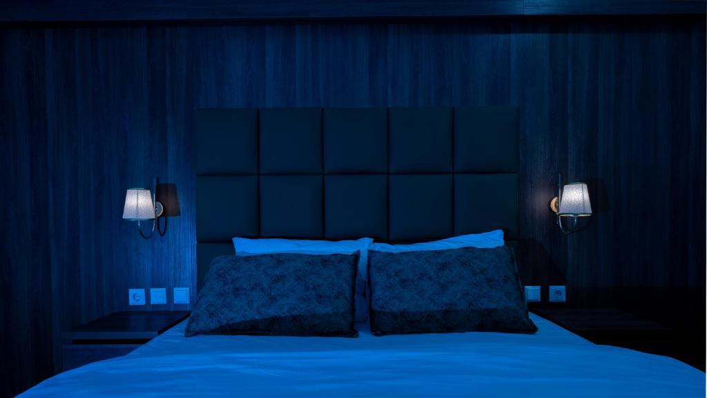 Postel nebo postele na pokoji v ubytování Hotel Cataleya