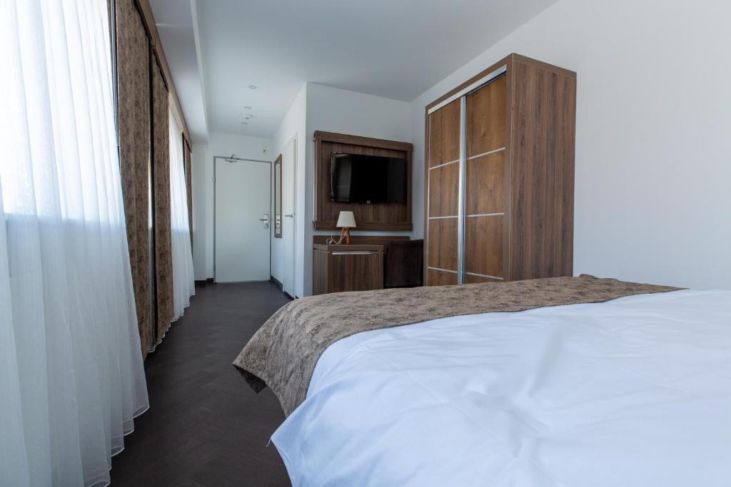 Postel nebo postele na pokoji v ubytování Hotel Cataleya