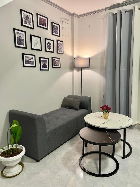 a living room with a couch and a table at NEW Modern Vacation Home Apartelle in Iriga City