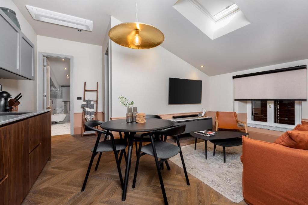 a kitchen and living room with a table and a couch at Martis Forum Heritage Hotel & Residence in Poreč