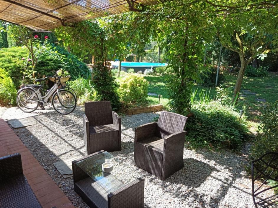 a patio with chairs and a table and a bike at Holiday Home Il Moro Novo in Cortona