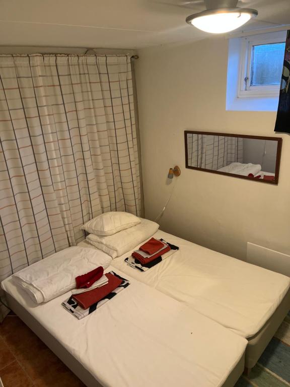two twin beds in a room with a window at 3-rumslägenhet i villa med havsutsikt i Båstad Hindbärsvägen 22 in Båstad