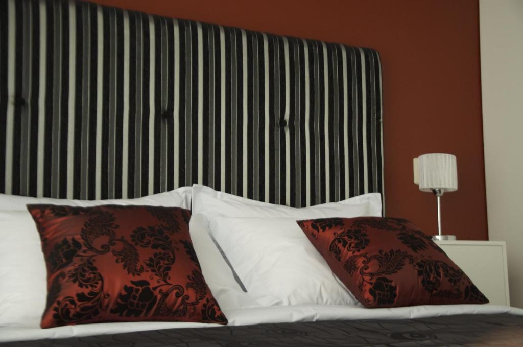 a bed with red and white pillows in a room at Miraflores Apartments in Lima