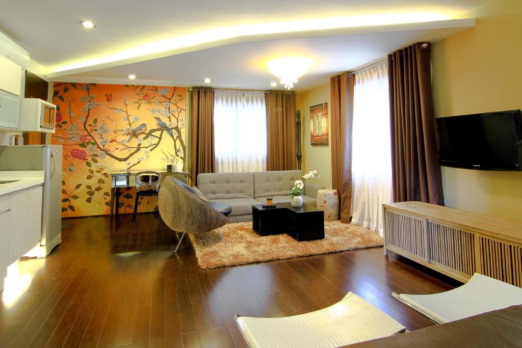 a living room with a couch and a tv at Boracay Suites in Boracay