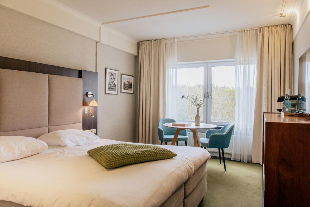 Postel nebo postele na pokoji v ubytování Grand Hotel Opduin