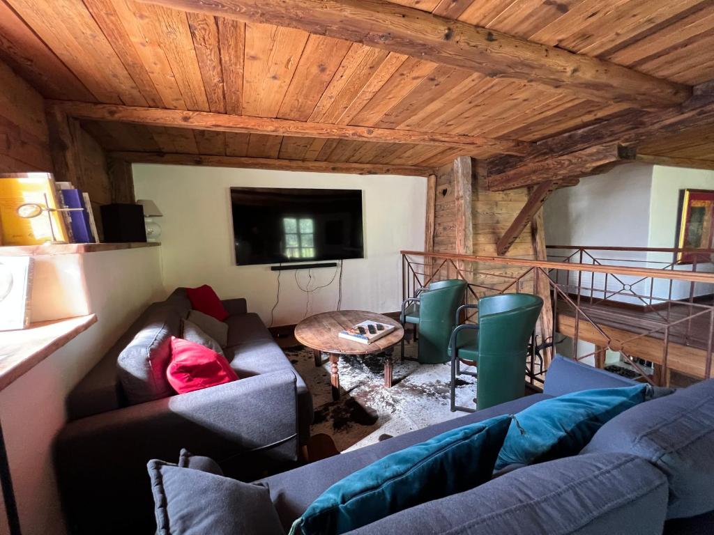 a living room with a couch and a table at Chalet Altus in Sainte-Foy-Tarentaise