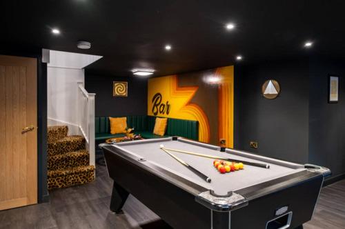 a billiard room with a pool table in it at Ultimate glam, vintage central pad. Cool 70s bar. in Bournemouth