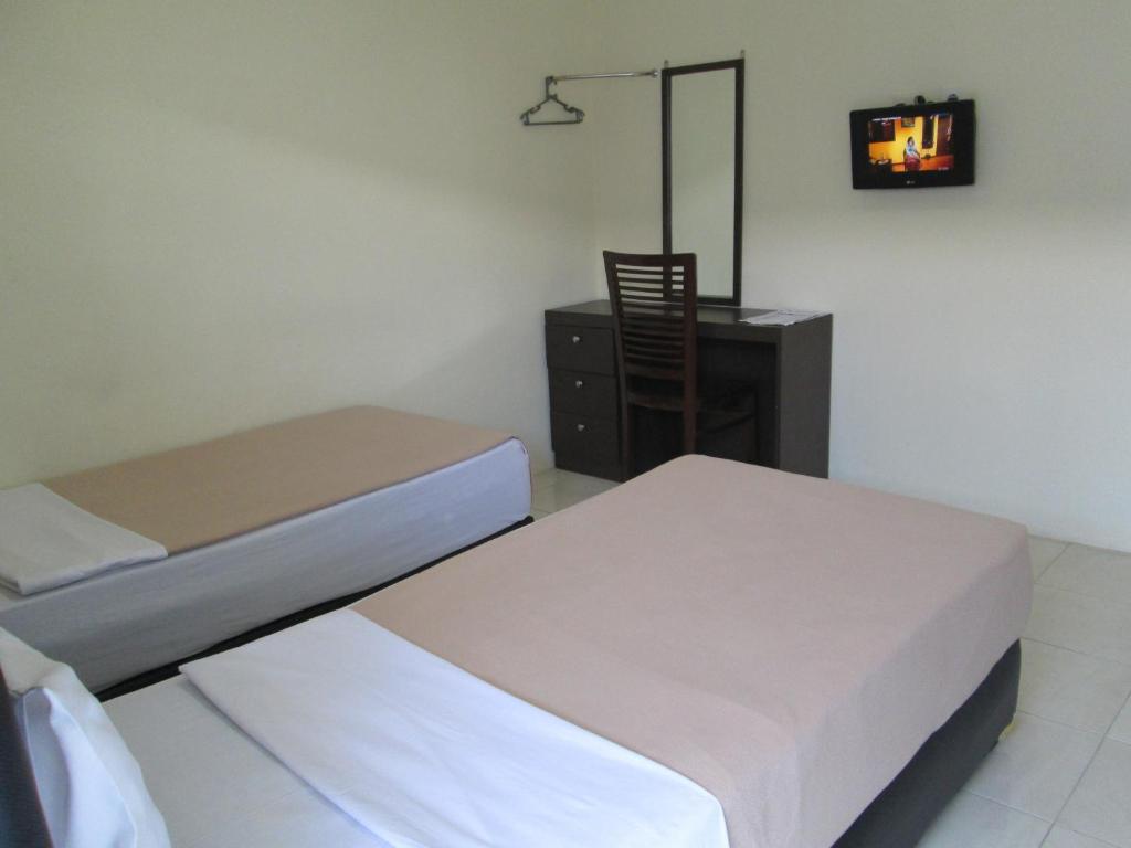 Postel nebo postele na pokoji v ubytování Mahkota Hotel