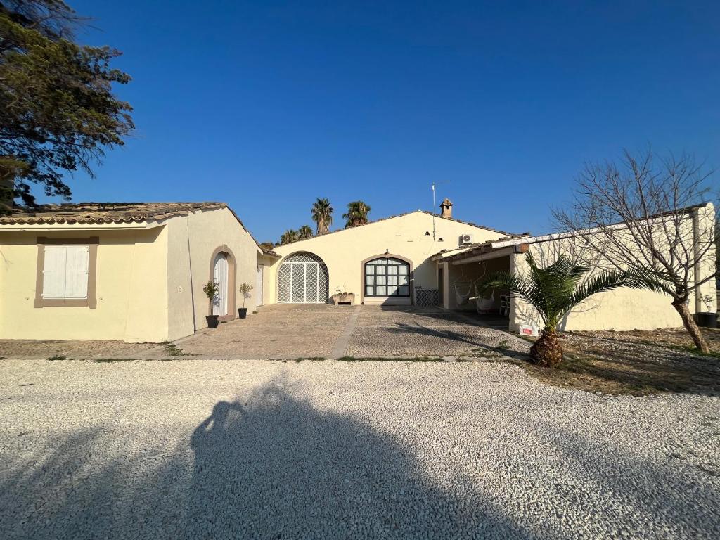 a house with a driveway in front of it at La Bouganville in Avola