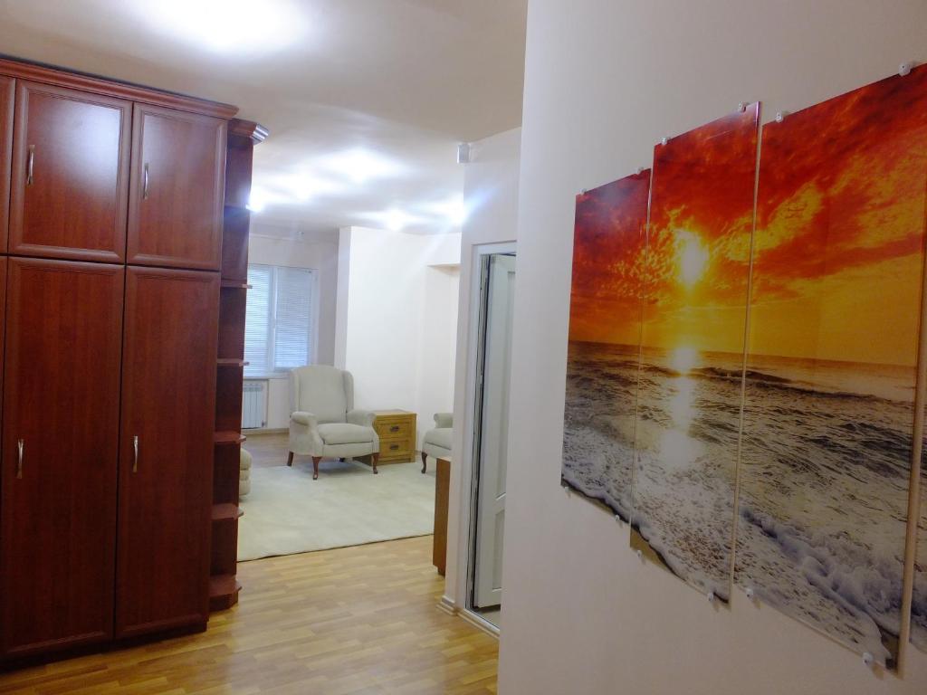 a living room with a painting on the wall at Top Apartments - Yerevan Centre in Yerevan