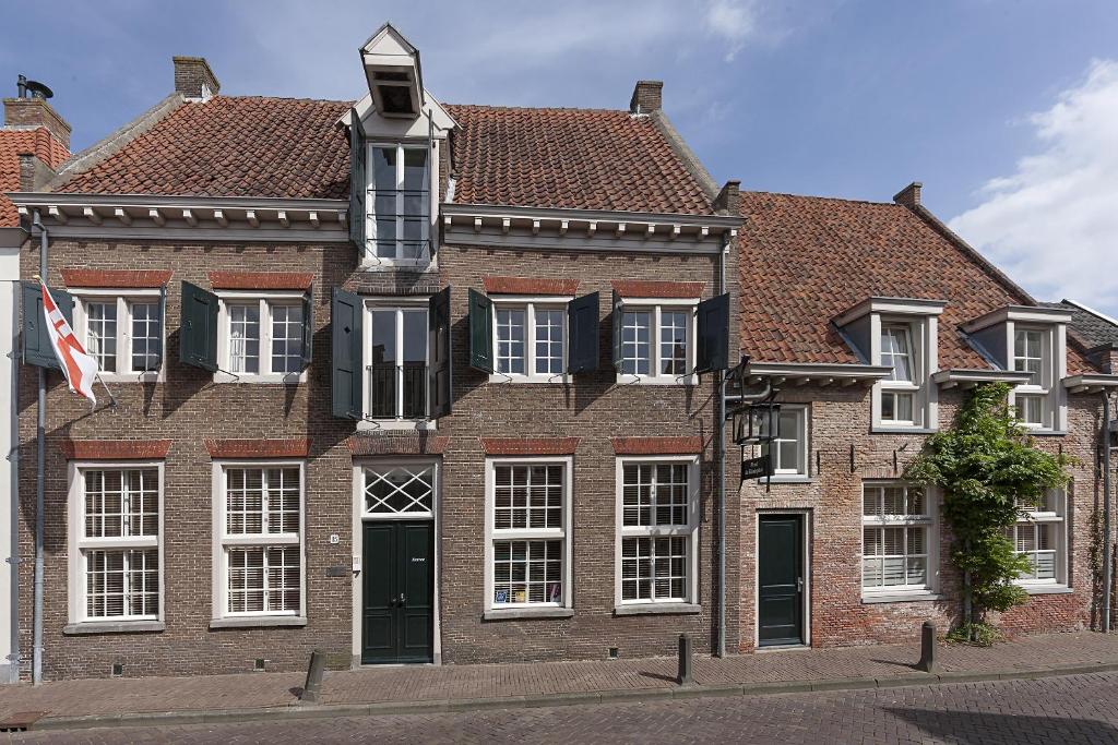 
a building with a clock on the front of it at Hotel de Tabaksplant in Amersfoort
