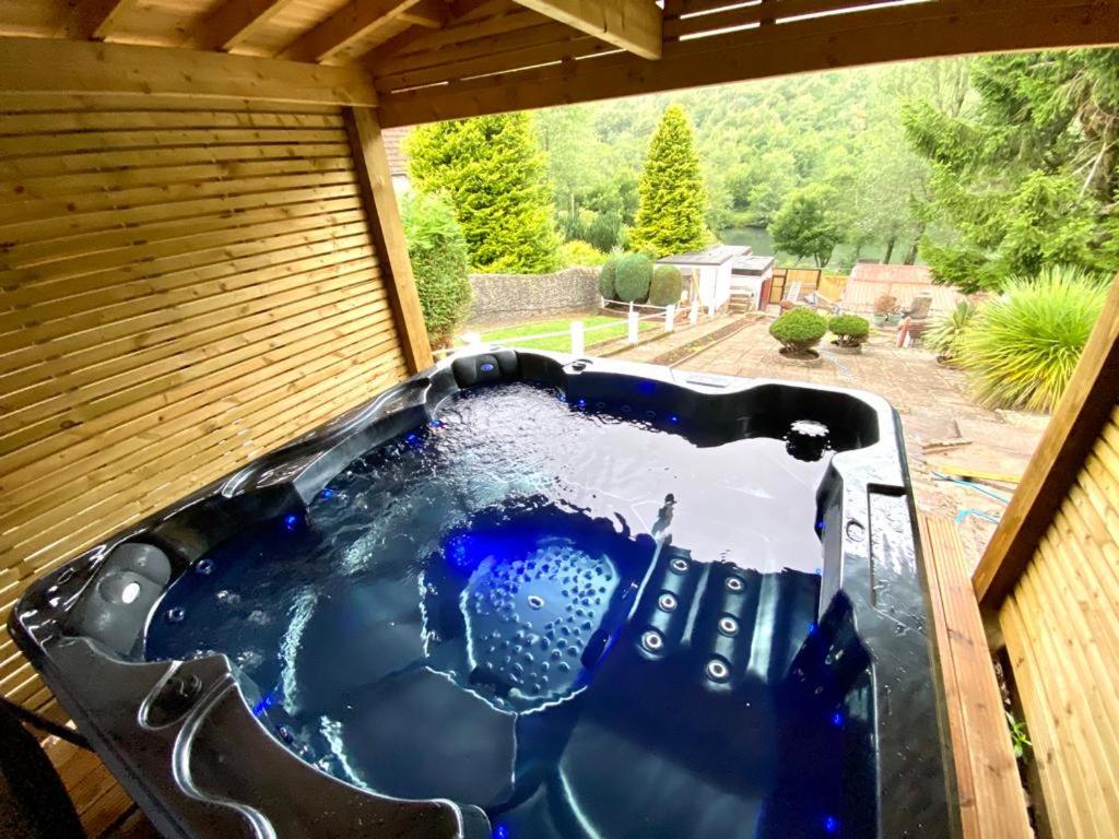 a hot tub in a backyard with a view at Lakeside View With Hot Tub in Abertillery